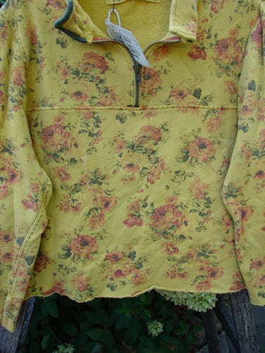 Magnolia Pearl NWT Cotton Fleece Asher Pullover Sweatshirt Vintage Rose Sunnies OSFA features a soft yellow fabric with vintage rose pattern and short front zipper, hanging on a hanger.