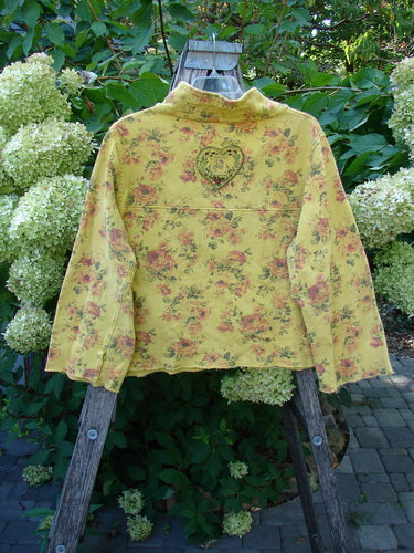 Magnolia Pearl NWT Cotton Fleece Asher Pullover Sweatshirt Vintage Rose Sunnies OSFA, featuring a floral motif and doodle-style heart, hangs on a ladder, showcasing its unique, artistic style.