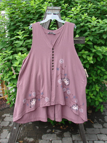 Image Alt Text: 1996 Moonsmile Vest with Daisy Chain and Ladybug Accents, a swingy and flirtatious pink dress on a swinger, featuring a V-shaped neckline, tiny buttons, and deep side seam pockets.