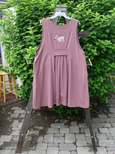 1996 Moonsmile Vest: Swingy and flirtatious pink dress with a V-shaped neckline, tiny buttons, and a varying curved hemline. Adorned with a daisy chain theme and sweet ladybug accents. Bust 50, Waist 56, Hips 60.