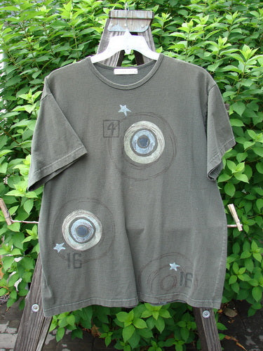 1998 Short Sleeved Tee Games Worn Domino Size 1: A t-shirt with circles and stars on it from Blue Fish Clothing's Summer Collection of 1998. Made from Mid Weight Organic Cotton, it features a rolled ribbed neckline, game theme paint, and the signature Games Patch. Bust 50, Waist 50, Hips 50, Length 30.