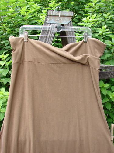 Barclay Cotton Lycra Fold Over Bottom Bell Skirt in Coco, Size 2, on a clothes line. Cross over front banded waistline, lower bell accent, and piped lower hem.