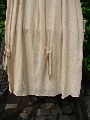 Barclay Gauze Tool Skirt Unpainted Kauiclla Size 2: A gauzy cotton skirt with a drawcord waistline, widening shape, and gathered fall. Accented with hand-dyed silk ribbon. Length: 40 inches.