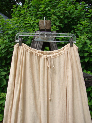 Image alt text: Barclay Gauze Tool Skirt, Size 2, unpainted, with drawcord waistline, widening shape, and gathered fall, accented with hand-dyed silk ribbon. Cotton gauze fabric. Length: 40".