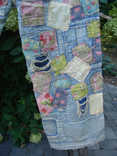 Magnolia Pearl NWT Denim Heavily Patched Miner Jean Garden Patch Washed Indigo OSFA features pastel floral and solid patches on light-wash denim, showcasing frayed edges and intricate stitchery against an outdoor setting.