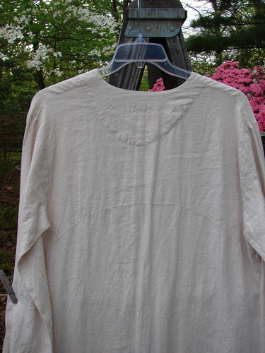 1999 NWT Cream and Sugar Coat Tea Time Teadye OSFA displayed on a hanger, showcasing its unique lower drape, upward scoop front hem, and oversized shell button closure.