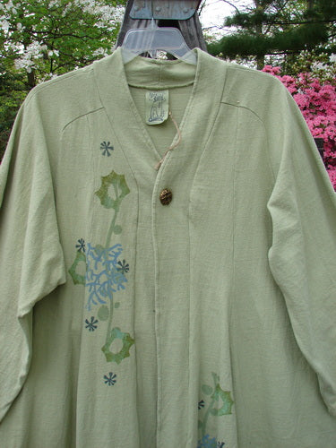 1996 Reprocessed Spring Rain Jacket Coral Reef Seedling OSFA with a flower design, vintage closure, A-line shape, deep side pockets, and belled side accents. Suitable for various body sizes.