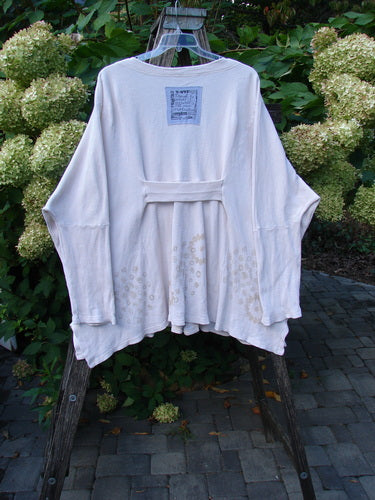 1997 Thermal Voyage Roadside Jacket Windy Floral Shell OSFA draped on a step-ladder, showcasing its loose fit, dropped shoulders, deep V-neck, sash detail, and floral embroidery along the hem.