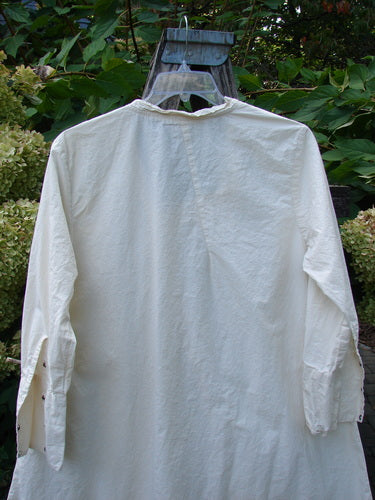 Magnolia Pearl Cotton Poplin Wabi Diagonal Tunic Natural OSFA, shown from the back, features a loose fit, long sleeves with buttoned cuffs, and unique diagonal seams, embodying the creative freedom Bluefishfinder.com celebrates.