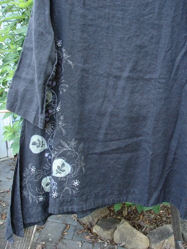 Barclay Linen Tall Vent Tunic Side Garden Black Size 1, featuring tall vented sides, A-line flair, rounded neckline, three-quarter sleeves, and flowy shape, captured in a close-up showcasing its detailed texture.