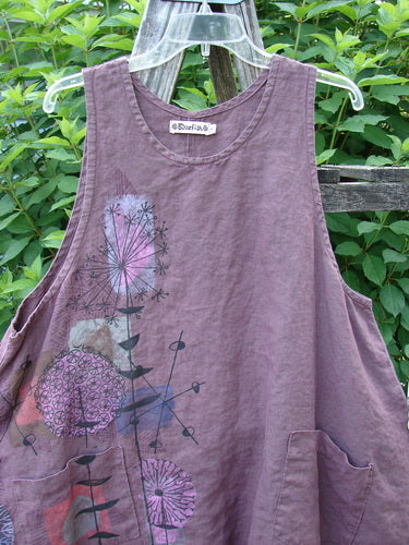 Barclay Linen Two Pocket Shirttail Pinafore Starburst Plum Wine Size 1 features a rounded neckline, A-line flair, and double drop pockets with a painted starburst design, showcasing a flowy shape.