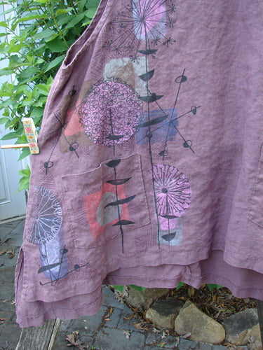 Barclay Linen Two Pocket Shirttail Pinafore Starburst Plum Wine Size 1, showcasing an A-line flair, rounded neckline, double exterior pockets, and starburst pattern, highlighting its flowy shape and medium weight linen texture.