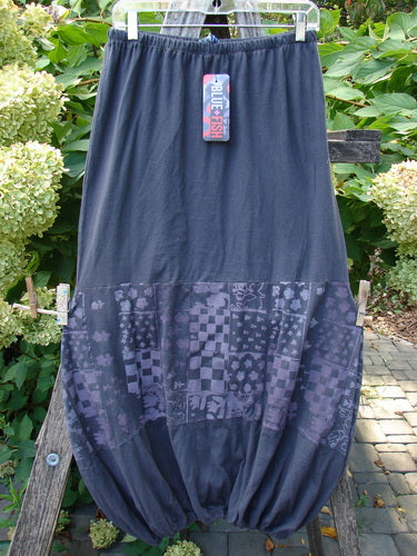 Barclay NWT Sprig Skirt Grid Garden Black Sand Size 0 featuring a bubble-style silhouette with geometric and floral motifs on the lower half, hanging outdoors, showcasing Blue Fish's artistic, organic design ethos.
