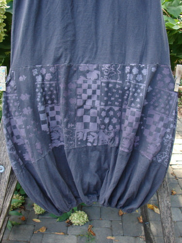 Barclay NWT Sprig Skirt Grid Garden Black Sand Size 0, featuring a charcoal balloon-style shape with a checker-and-floral patchwork motif, hangs outdoors, showcasing its paneled, painted lower design.