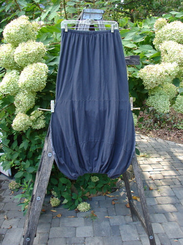 Barclay NWT Sprig Skirt Grid Garden Black Sand Size 0 featuring a gathered hem and elastic waistband, displayed on a hanger against a patio backdrop with white hydrangeas.