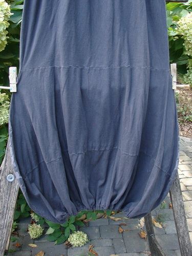 Barclay NWT Sprig Skirt Grid Garden Black Sand Size 0: A lightweight, charcoal bubble-hem skirt with a paneled, painted lower section and full elastic waist, clipped on a wooden railing amidst garden plants.