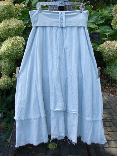 Barclay NWT Batiste Fold Over Raglan Silhouette Skirt Unpainted Dew Size 1 displayed outdoors, featuring a wide waistband, two-tiered flowing design, raw-edge hem, and generous hips for a graceful, vintage style.