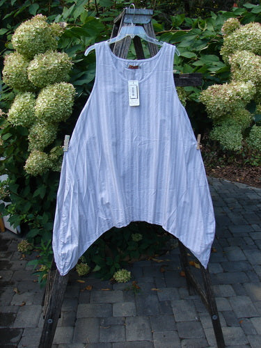 Barclay NWT Percale Hado Shift Stripe Smoke Pearl Size 1 tunic hangs by its straps on a wooden ladder. Its sleeveless, A-line shape and varying pinstripes complement its airy cotton percale fabric.