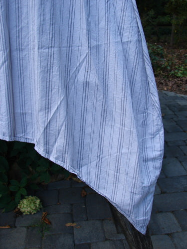 Barclay NWT Percale Hado Shift in Stripe Smoke Pearl, draped over a branch. Features include a deeper scoop neckline, A-line shape, and varying hem. Perfect for creative expression.