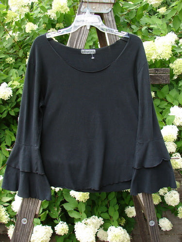 Barclay Cotton Lycra Long Sleeved Petal Top Unpainted Black Size 0: A black shirt on a swinger with rounded neckline, fluttered lowers, and curly stitchery.