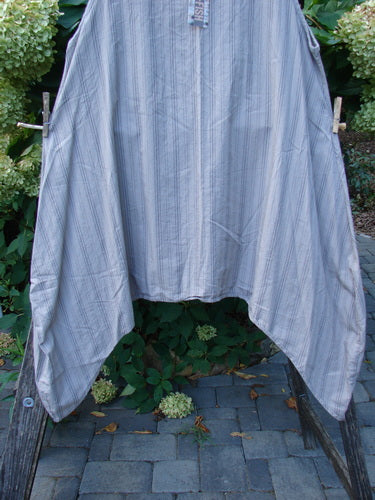 Barclay NWT Percale Hado Shift Stripe Moon Rock Sand Size 1 displayed outdoors, draped over wooden supports, showcasing its crisp, lightweight cotton percale with vertical pinstripes and varying hem design.