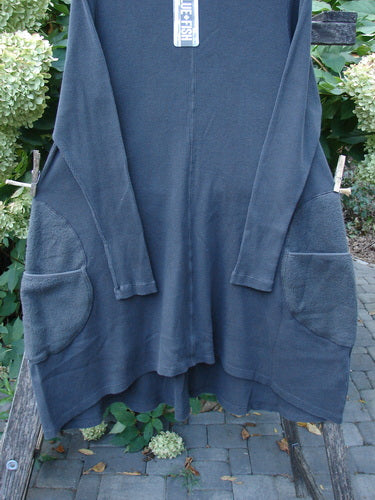 Barclay NWT Thermal Cloud Forest Pocket Tunic Unpainted Smoke Size 0 draped on a wooden bench, showcasing its long sleeves, A-line flare, scooped hemline, and large front pockets.