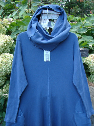 Barclay NWT Thermal Cloud Forest Pocket Tunic Top Unpainted Vintage Indigo Size 1, featuring a cowl neckline, long sleeves, front patch pockets on a hanger with a lush outdoor backdrop.