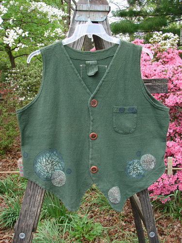 Vintage 1995 Reprocessed Drawing Room Vest featuring Star Spin design in Green Tea. Ceramic button front, tailored draw cord back, front pocket, and Blue Fish signature patch. Perfect for creative expression.