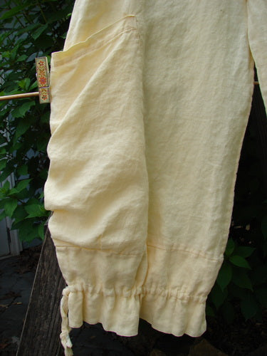 Barclay Linen Tie Bottom Pocket Bloomer Buttercup Size 1 features front drop pockets, elastic waist, blooming lowers with pull ties, and belt loops, crafted from medium weight linen in a slightly cropped style.