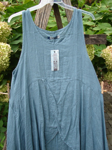 Barclay NWT Linen Tulip Midlayer Overpiece Unpainted La Mer Size 0, featuring a sleeveless, teal-blue design with a scooped neckline, layered cross-over front, and A-line flare, hanging gracefully.