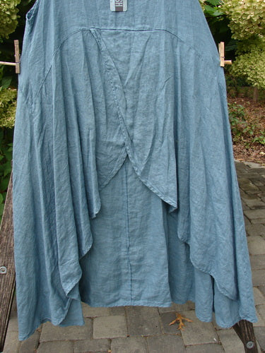 Barclay NWT Linen Tulip Midlayer Overpiece Unpainted La Mer Size 0 features a layered crossover front, uneven hemline, and flowing design, hanging on a clothesline with original tag visible.