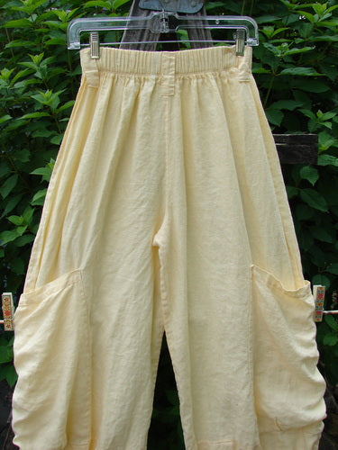 Barclay Linen Tie Bottom Pocket Bloomer Buttercup Size 1 hanging outdoors, showcasing its elastic waistline, two front pockets, blooming lowers with pull ties, and belt loops, reflecting Bluefishfinder.com’s vintage style.