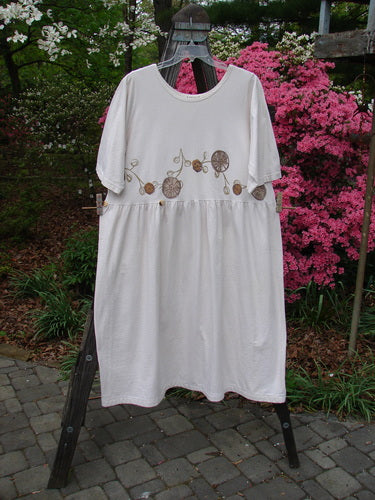 Vintage 1994 Flower Garden Dress with Garden Trail motif, altered in Ecru, size 2. Mid Weight Cotton Jersey fabric, Scooped Neckline, Drop Straight Waist Seam, Generous Folds, Two Button Side Accent. Bust 52, Waist 54, Hips 70, Sweep 120, Length 48.