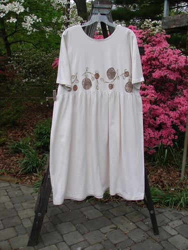 Vintage 1994 Flower Garden Dress with Garden Trail design, altered in Ecru, Size 2. Mid Weight Cotton Jersey, Scooped Neckline, Drop Waist Seam, Generous Folds, Two Button Side Accent. Bust 52, Waist 54, Hips 70, Length 48.