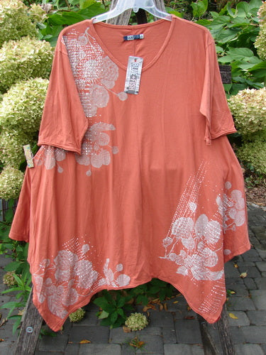 Barclay NWT Origami Tunic Top Berrie Patch Orange Cachi Size 0, featuring elbow-length sleeves, asymmetrical hem, and a white floral pattern, displayed with retail tag on a clear hanger.
