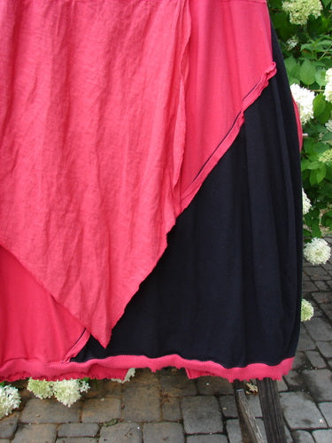 Barclay NWT Mixed Media Swatch Skirt: A close-up of a black and rose skirt with multiple directional swatches and layered upper. Vented front and full back hemline. Full elastic waistline. Size 2.
