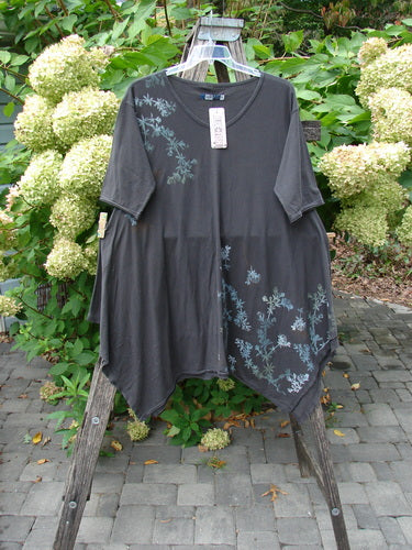Barclay NWT Origami Tunic Top Floral Branch Black Sand Size 0 displayed outdoors, showcasing asymmetrical hem, floral branch print, and unique cut details, emphasizing individuality and creativity from Bluefishfinder.com.