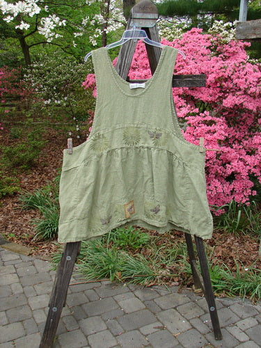 Vintage 1998 Botanicals Leafhopper Jumper Apron on clothesline, showcasing nature-themed design in heavy linen. From BlueFishFinder's collection, embodying creative freedom and individuality through unique, one-size-fits-all fashion.