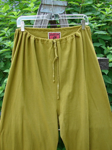 Barclay Bow Bottom Pantaloon in Unpainted Green Olive Size 0 displayed on a clothesline, featuring full elastic waistline, drawcord, and textured ribbon bows with buttonholes at cuffs.