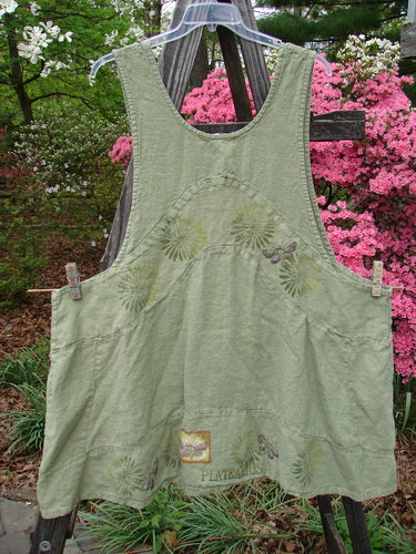 1998 Botanicals Leafhopper Jumper Apron Butterfly Elm OSFA hanging on a clothesline, showcasing a green apron with nature-themed paint, perfect for layering. Vintage Blue Fish Clothing from BlueFishFinder.com.