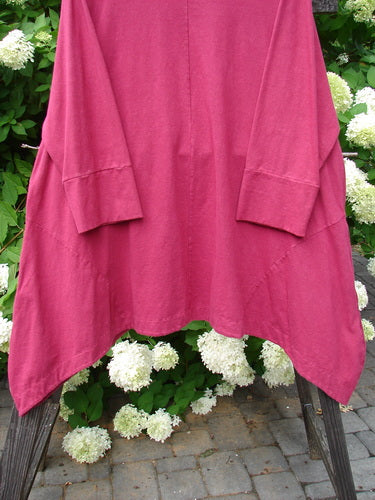 A pink Barclay Cotton Lycra Igloo Tunic Dress in Hollyberry, size 2, on a rack. Features include a rounded neckline, drop side pockets, and a sweeping hemline. Bust: 58, Waist: 58, Hips: 64.