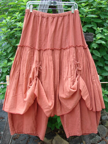 Barclay Hemp Linen Batiste Fusion Pant Skirt Autumn Harvest Size 0, showcasing a full elastic waist, triangular patches, double tie accents, and a slightly cropped under pant on a clothesline.