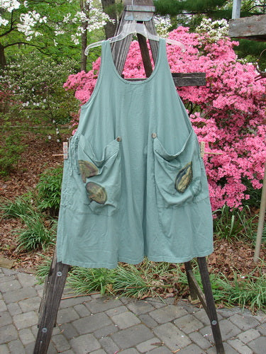 Vintage Blue Fish Clothing: 1998 Harvest Pinafore in Organic Garden Kale Size 1. Features include drawcord gathers, oversized painted pockets, six sectional panels, and original buttons. Versatile design for creative expression.