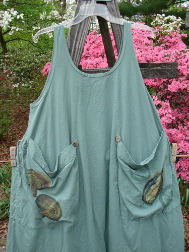 Vintage 1998 Harvest Pinafore Organic Garden Kale Size 1 on a clothes rack, featuring oversized painted pockets, six sectional panels, and original buttons. A unique smock-style dress from BlueFishFinder's curated collection.