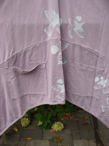 Barclay NWT Perfect Day Pocket Tunic Dress Love Dove Sea Fog Size 0 draped over a chair, showcasing its bird-heart stencil print, oversized pockets, and lettuce-edged sleeves, reflecting Bluefishfinder.com's unique vintage style.