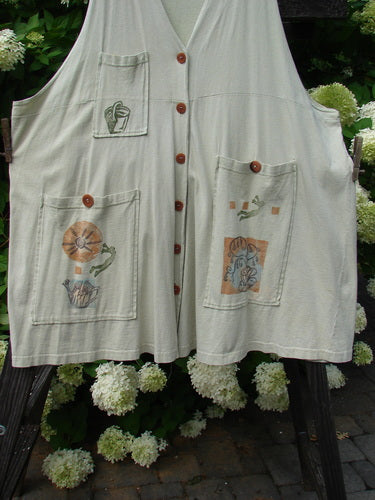 1994 Fishing Vest Magic Garden Aloe OSFA: A white vest with a design on it, featuring three painted pockets and original vintage buttons.