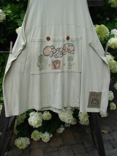 1994 Fishing Vest Magic Garden Aloe OSFA: A medium weight cotton jersey vest with a magic garden theme paint. Features include an A-line shape, painted pockets, and vintage buttons.