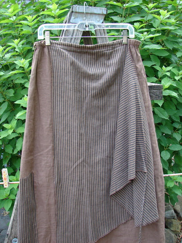 Barclay Linen Every Way Apron Skirt Stripe Mocha Size 0 on a clothesline, showcasing full elastic waist, striped side layer apron, widening hemline, draw wrap cord, and exterior stitchery.