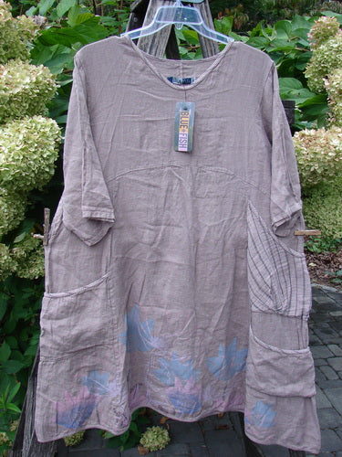 Barclay NWT Linen Calotype Stack Pocket Dress in Oriel, featuring a round neckline, three-quarter sleeves with roll tabs, patch pockets, and subtle leaf-print hem, displayed outdoors.