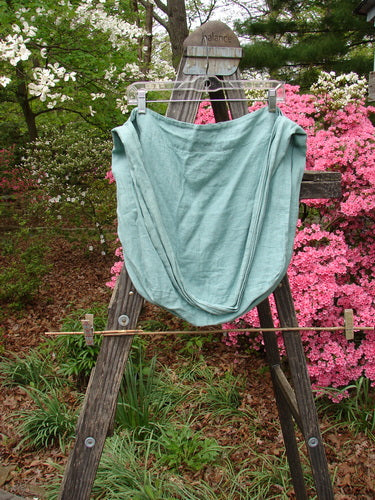 Barclay Linen Sling featuring a Berry Field theme in Spring Rain on a wooden easel outdoors. Wide shoulder sling, rounded sides, slouchy look. Perfect vintage Blue Fish Clothing from BlueFishFinder.com.